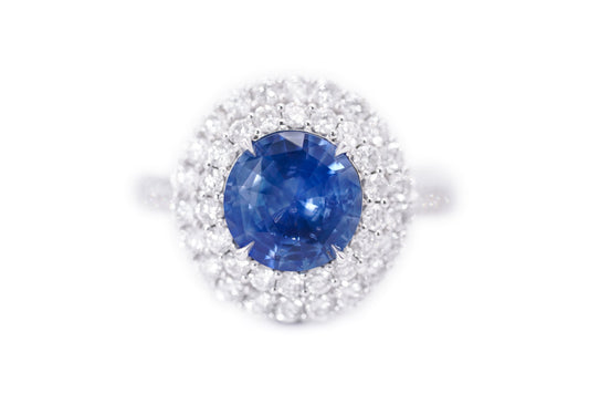 "Enchanted Elegance: Round-Cut Sapphire and Diamond Halo Ring"