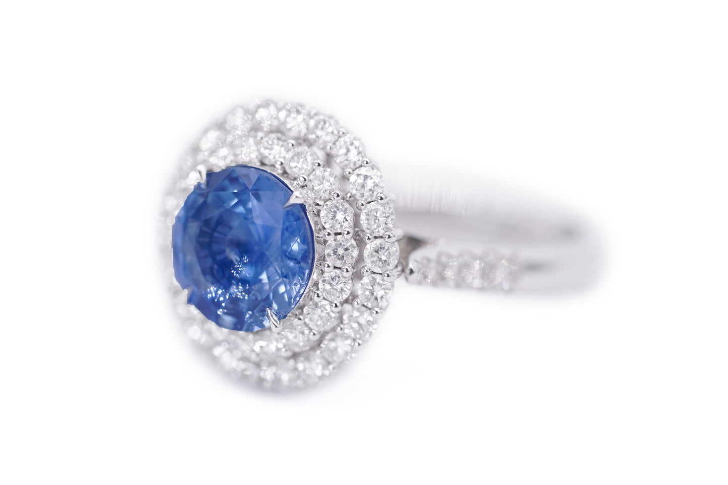 "Enchanted Elegance: Round-Cut Sapphire and Diamond Halo Ring"