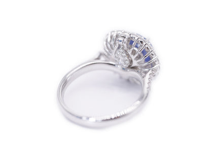 "Enchanted Elegance: Round-Cut Sapphire and Diamond Halo Ring"